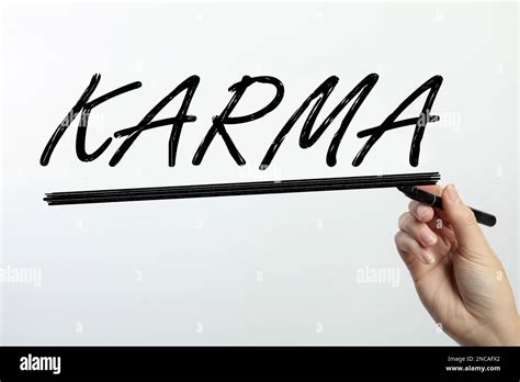 Woman Writing Word Karma On Glass Against White Background Closeup