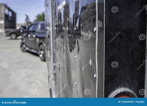 Trailer Being Pulled By A Truck In Industrial Parking Lot Stock Photo