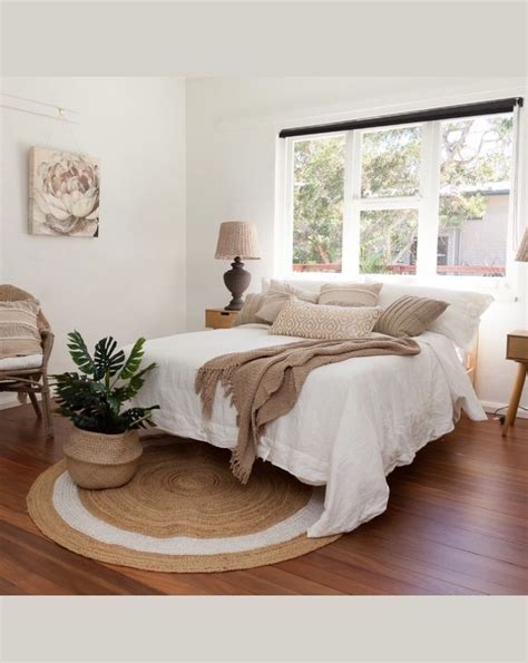 A Bedroom With A Bed Chair And Potted Plant On The Floor In Front Of A