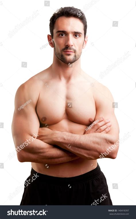 Fit Man Standing Shirtless With His Arms Crossed In A White Background