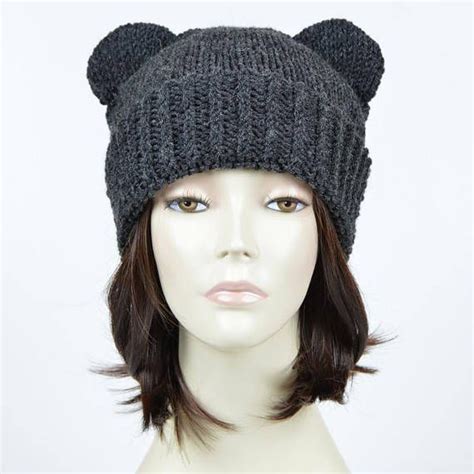 A Mannequin Head Wearing A Knitted Hat With Bear Ears On Its Side