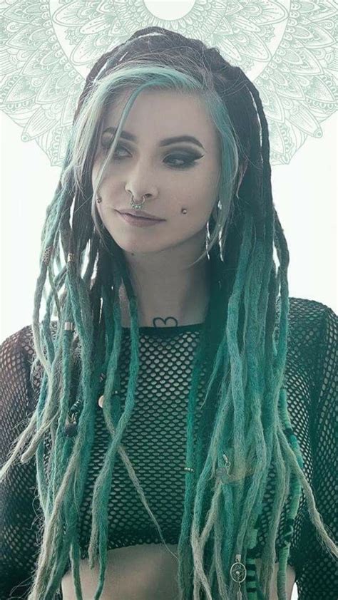 A Woman With Long Green Dread Locks And Piercings