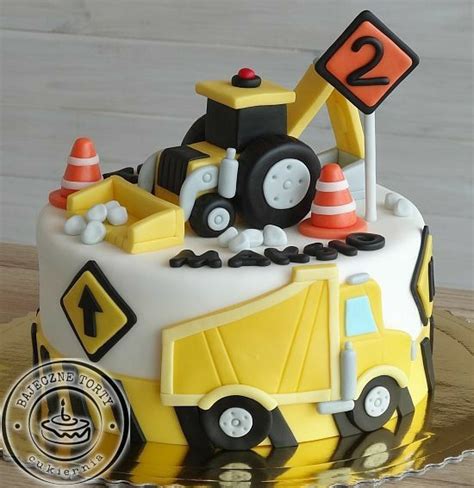 A Birthday Cake With Construction Vehicles On It