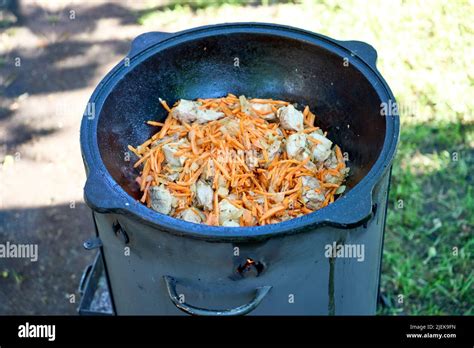 Cooking Pilaf In A Cauldron On Fire In The Garden Stock Photo Alamy