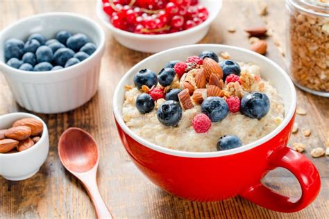 Oatmeal Porridge With Fresh Berries Fruits And Nuts Stock Photo