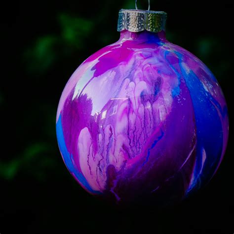 First Batch Of Clear Glass Ornaments Transformed With Drops Of Acrylic Paint Inside And Swirlin