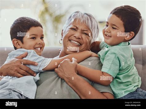 Love Grandmother And Boys On Couch Smile And Playful On Weekend