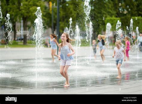Cute Young Sisters Playing In Fountains On Newly Renovated Lukiskes