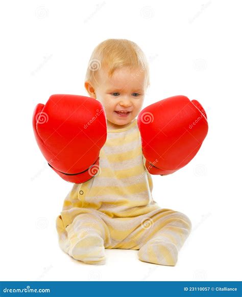 Cute Baby In Boxing Gloves Sitting On Floor Royalty Free Stock