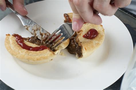 Free Stock Photo 10476 Man Eating A Tasty Meat Pie Freeimageslive