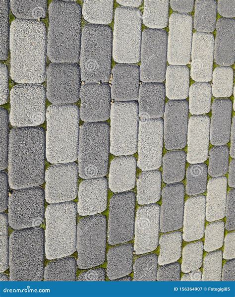 Industrial Background Of Paving Slabs With Overgrown With Moss In The