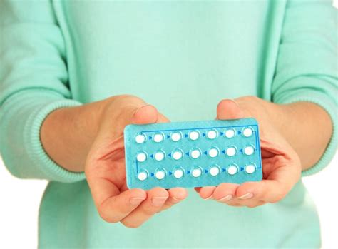 Premium Photo | Hormonal pills in female hands isolated on white