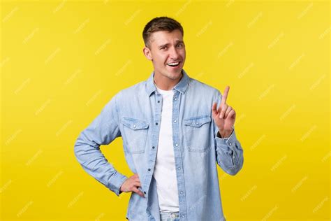 Free Photo Cheerful Smiling Blond Man Shaking Finger Tell Not So