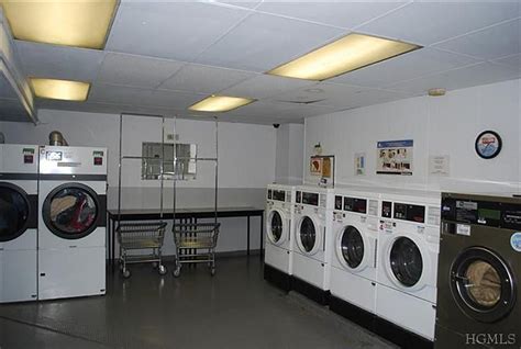 Common Laundry Room Conveniently Located In Building Apartment