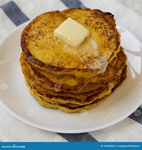 Homemade Corn Meal Johnny Cakes With Butter On A White Plate Low Angle