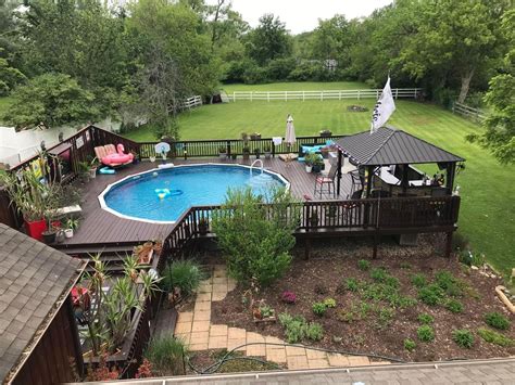 An Aerial View Of A Backyard With A Pool Deck And Hot Tub In The Middle