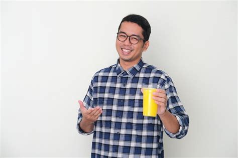 Premium Photo Adult Asian Man Smiling Happy While Presenting A Cup Of