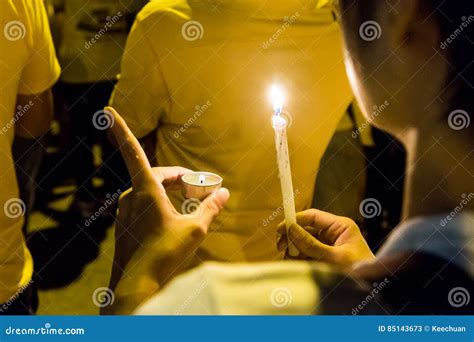 People Holding Candle Vigil In Darkness Seeking Hope Worship P Stock