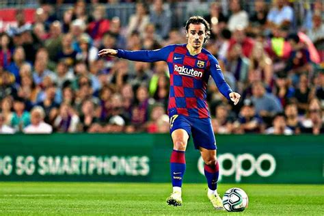 A Man Kicking A Soccer Ball On Top Of A Field