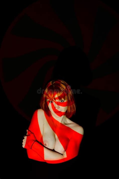 Portrait Of A Beautiful Naked Woman In The Red Beams Of The Projector