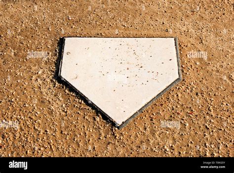 Home plate surrounded by dirt on a softball field Stock Photo - Alamy