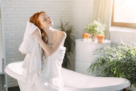 Restful Relaxing Redhead Caucasian Young Woman Drying Her Coppery Hair