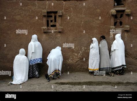 Ethiopian Orthodox Women Wearing White Capes Praying In Front Of The