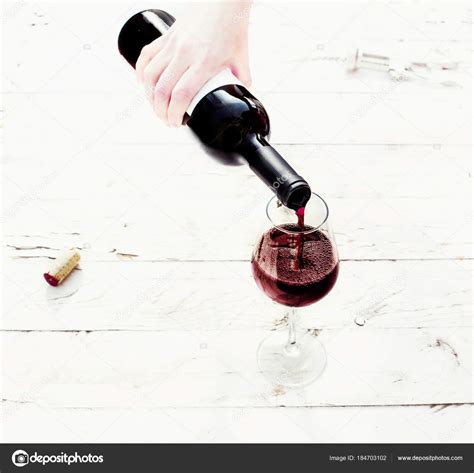 Hand Pouring Glass Of Wine