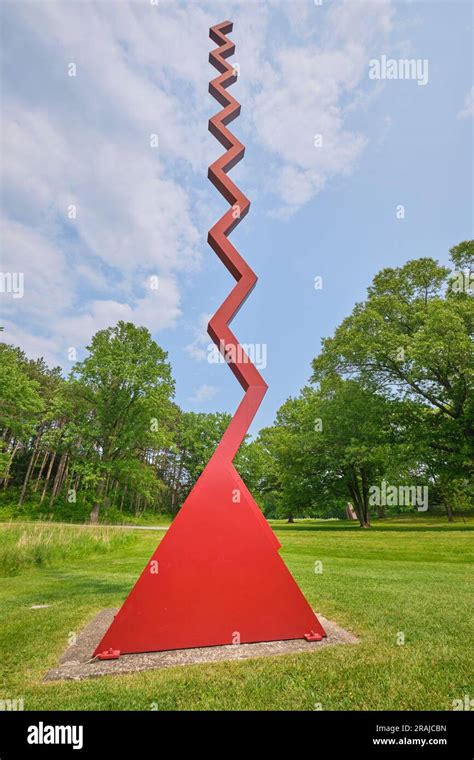 A View Of The Tall Red Squiggly Line Sculpture Titled Endless Column