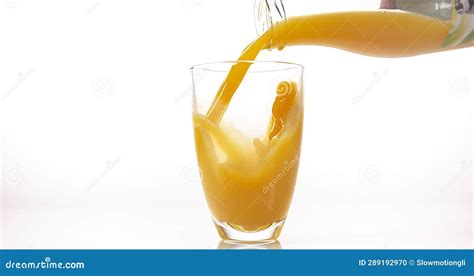 Orange Juice Being Poured Into Glass Against White Background Stock