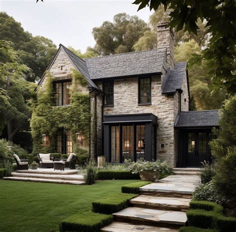 A Stone House With Steps Leading Up To The Front Door And Lawn In Front