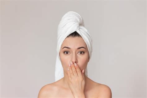 Premium Photo Naked Woman With White Towel Wrapped Around Her Head Who Covers Her Mouth With