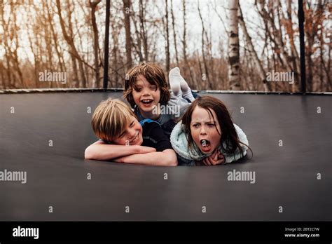 Three Children Playing On A Trampoline Usa Stock Photo Alamy