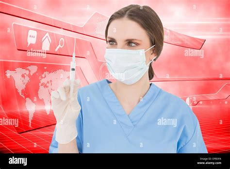Composite Image Of Pretty Brunette Female Doctor Holding A Syringe And