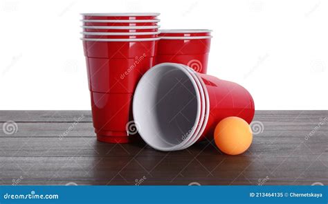 Plastic Cups And Ball For Beer Pong On Wooden Table Against White