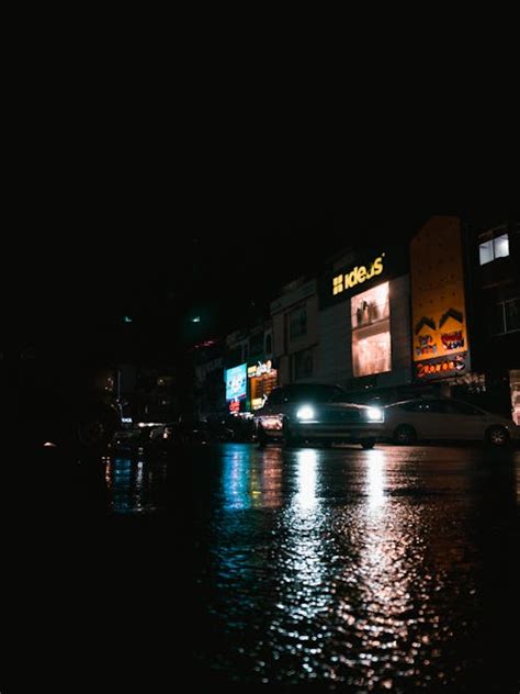 Cars Driving on Illuminated Night City Street · Free Stock Photo