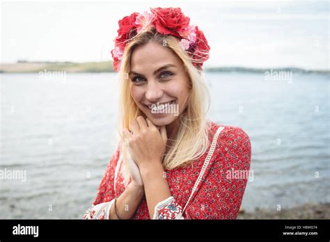 Blonde Woman Wearing A Flower Tiara Standing Near A River Stock Photo Alamy