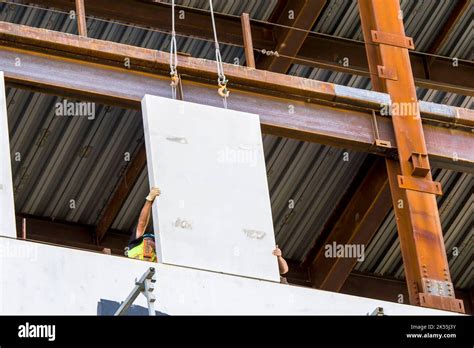 Installing A Wall Panel On The Exterior Of A Building Under