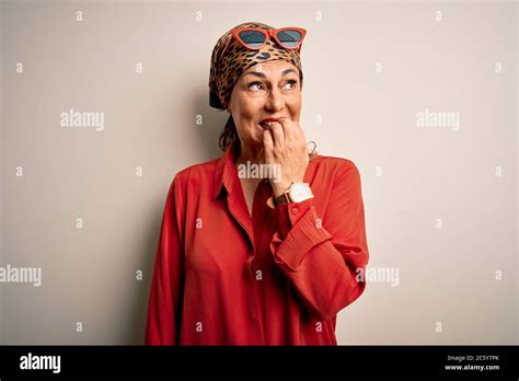 Middle Age Brunette Woman Wearing Handkerchief On Head And Shirt Over