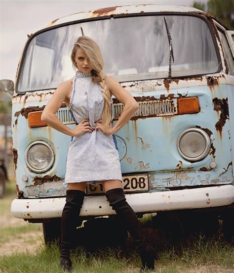 A Woman Standing In Front Of An Old Van