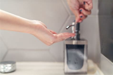 Mulheres Lavando Mão Com Sabonete Líquido Em Restroom Foto Premium