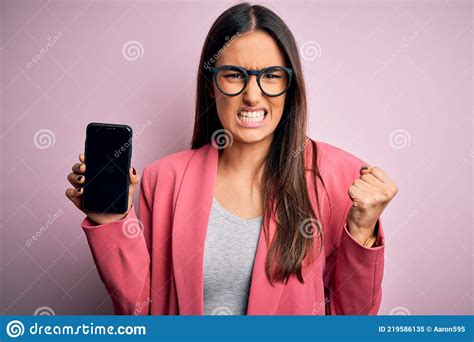 Young Beautiful Brunette Woman Wearing Glasses Holding Smartphone