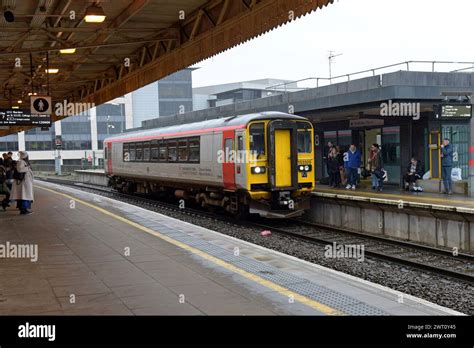 Passengers Getting On A Transport For Wales Class Sprinter Dmu