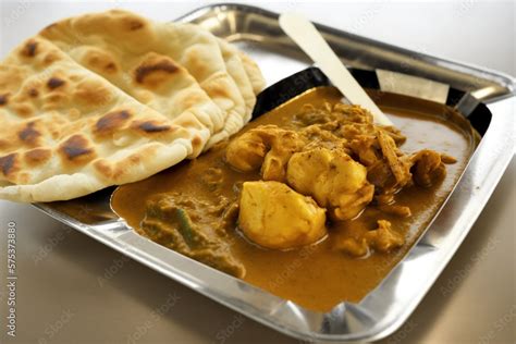 View of roti canai and chicken curry. Roti Canai and chicken curry is a ...