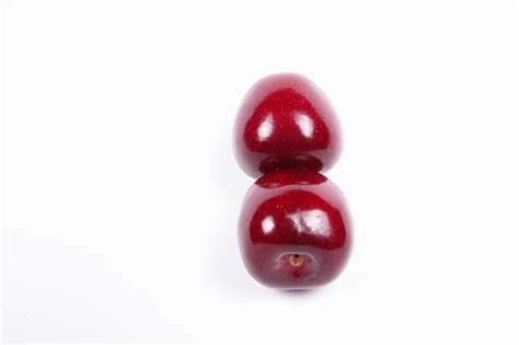 Premium Photo Two Sweet Juicy Red Cherries Isolated On A White