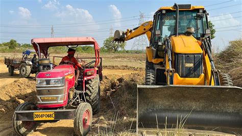 New Jcb 3dx Backhoe Machine Loading Mud In Mahindra YUVO And Swaraj