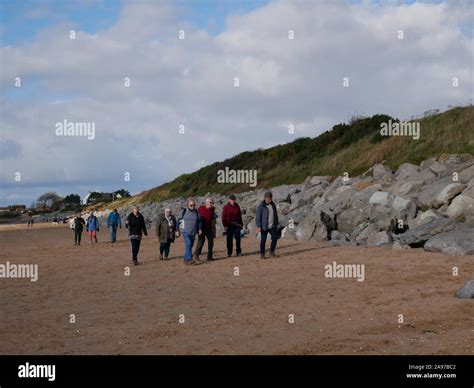 Group of people walking on the beach Stock Photo - Alamy