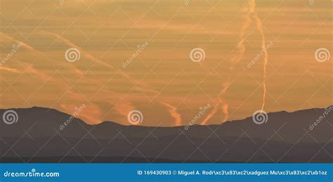 Nice Mountain Landscape At Sunset With Some Condensation Trails Stock