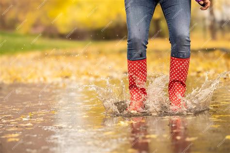 Premium Photo Woman Legs In Dotted Red Rubber Boots With Umbrella