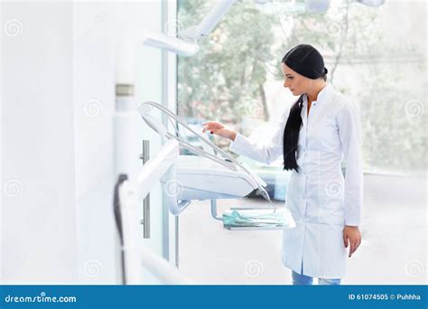 Dentist Doctor Prepares Equipment For A Work Dental Clinic Stock Image